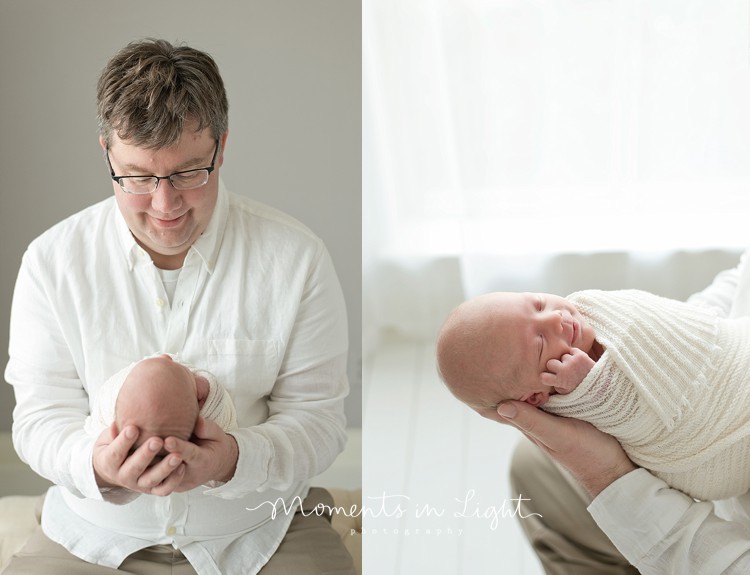 newborn baby with dad smiling by window in Montgomery, Texas