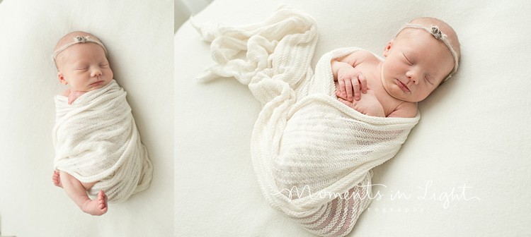 newborn in white swaddle in natural pose by window
