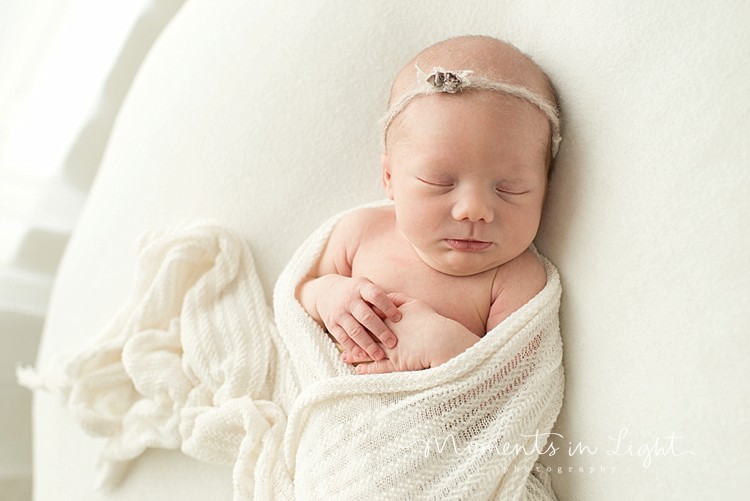 newborn baby girl swaddled in Montgomery Texas photography studio