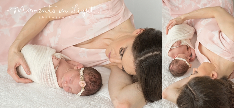 Mother in pink dress lying on the floor of a Houston photography studio with newborn 