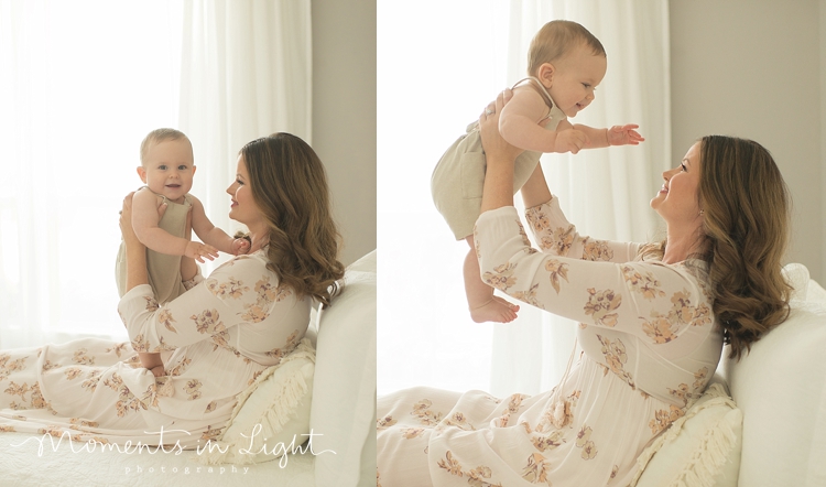 mom cuddling baby boy on white bed wearing floral dress in Houston photo studio