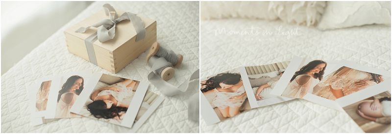 Some prints from a Houston newborn baby studio photography session lay on a bed. 
