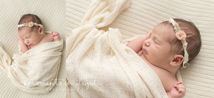 Sleeping baby girl wearing a floral headband by newborn photographer in Montgomery, Texas