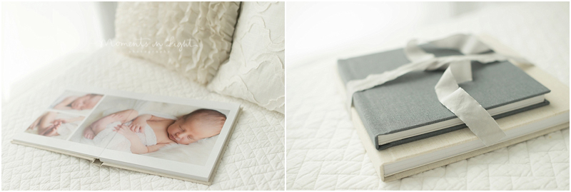A photo album from a Houston newborn baby studio photography session sits on a bed. 