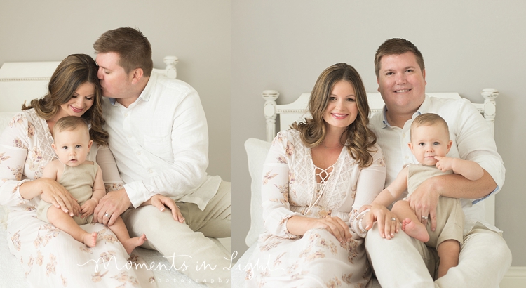 family photos of mom and dad with baby boy on bed in Houston photo studio